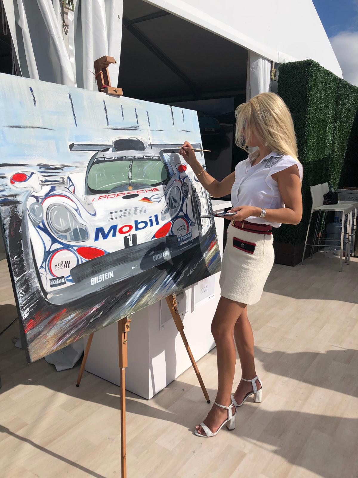 Tanja painting a Porsche at an easel