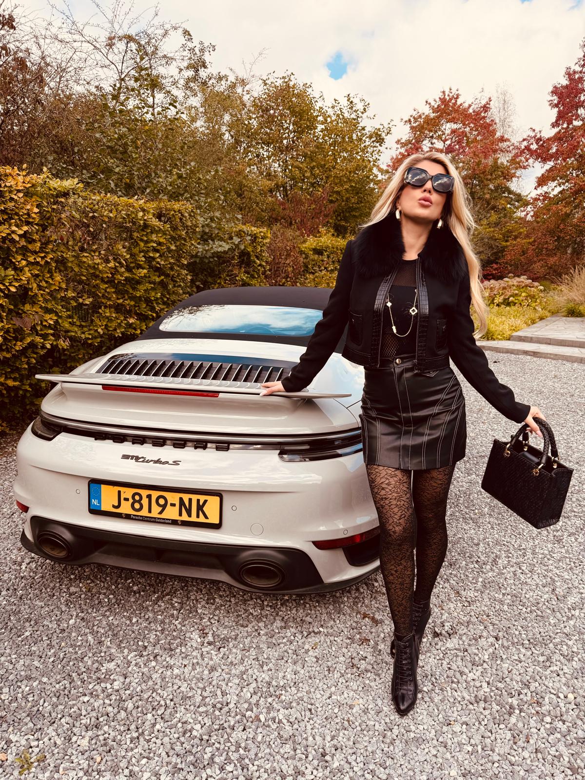 Tanja beside a silver Porsche