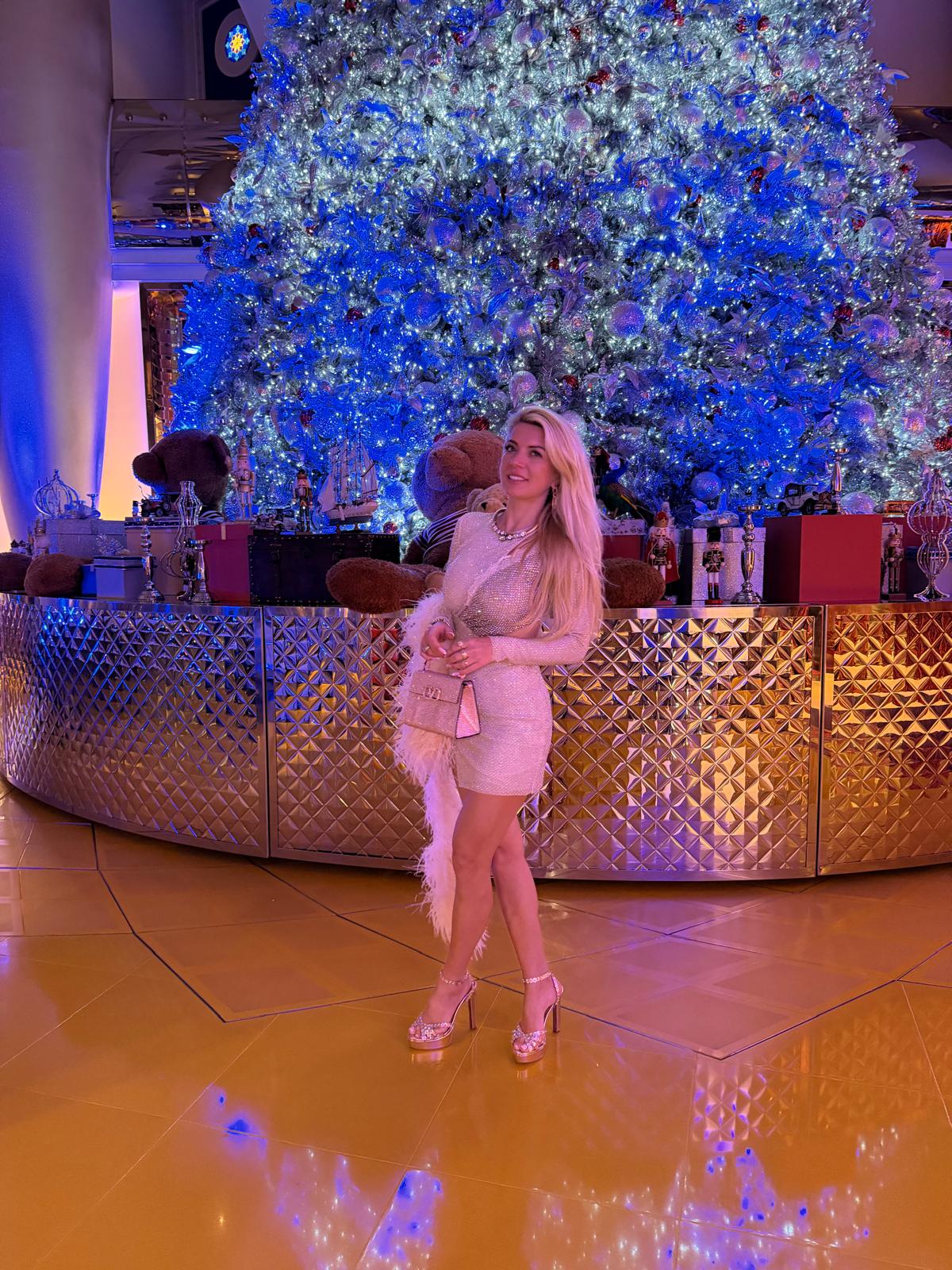 Tanja standing beside a Christmas tree
