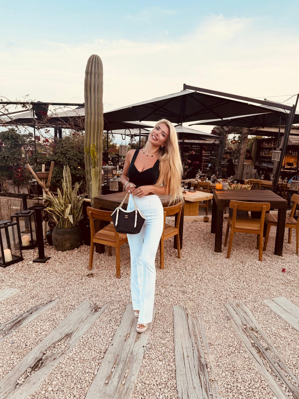Tanja smiling on an outdoor terrace