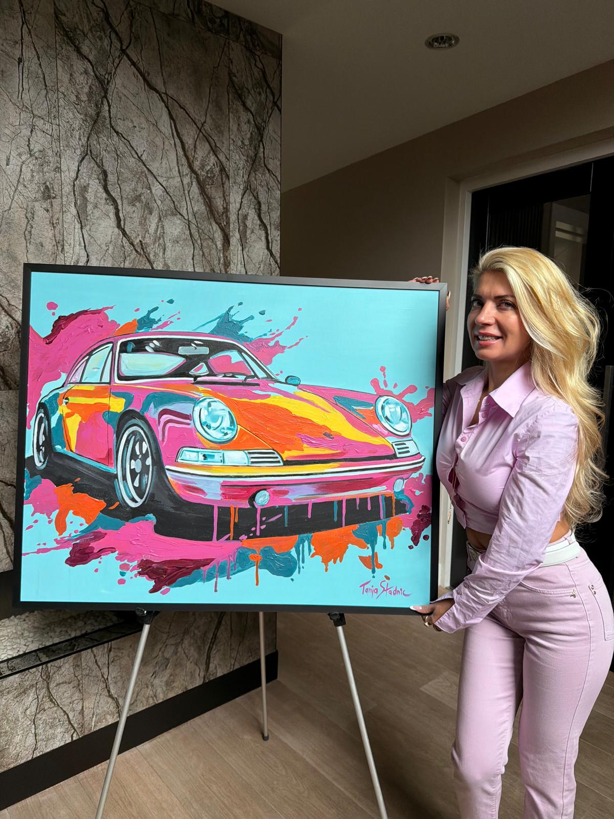 Tanja holding a colourful Porsche painting